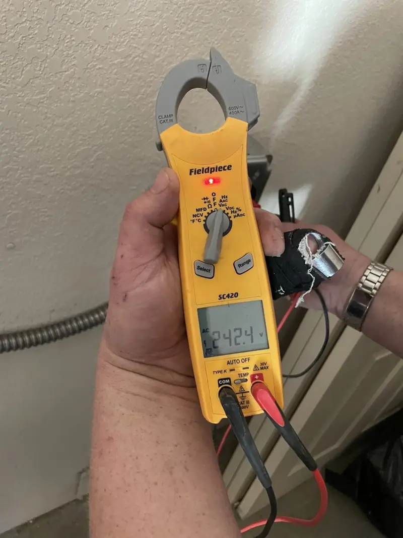 Voltage testing with clamp meter during Recessed Lighting Installation in Elma